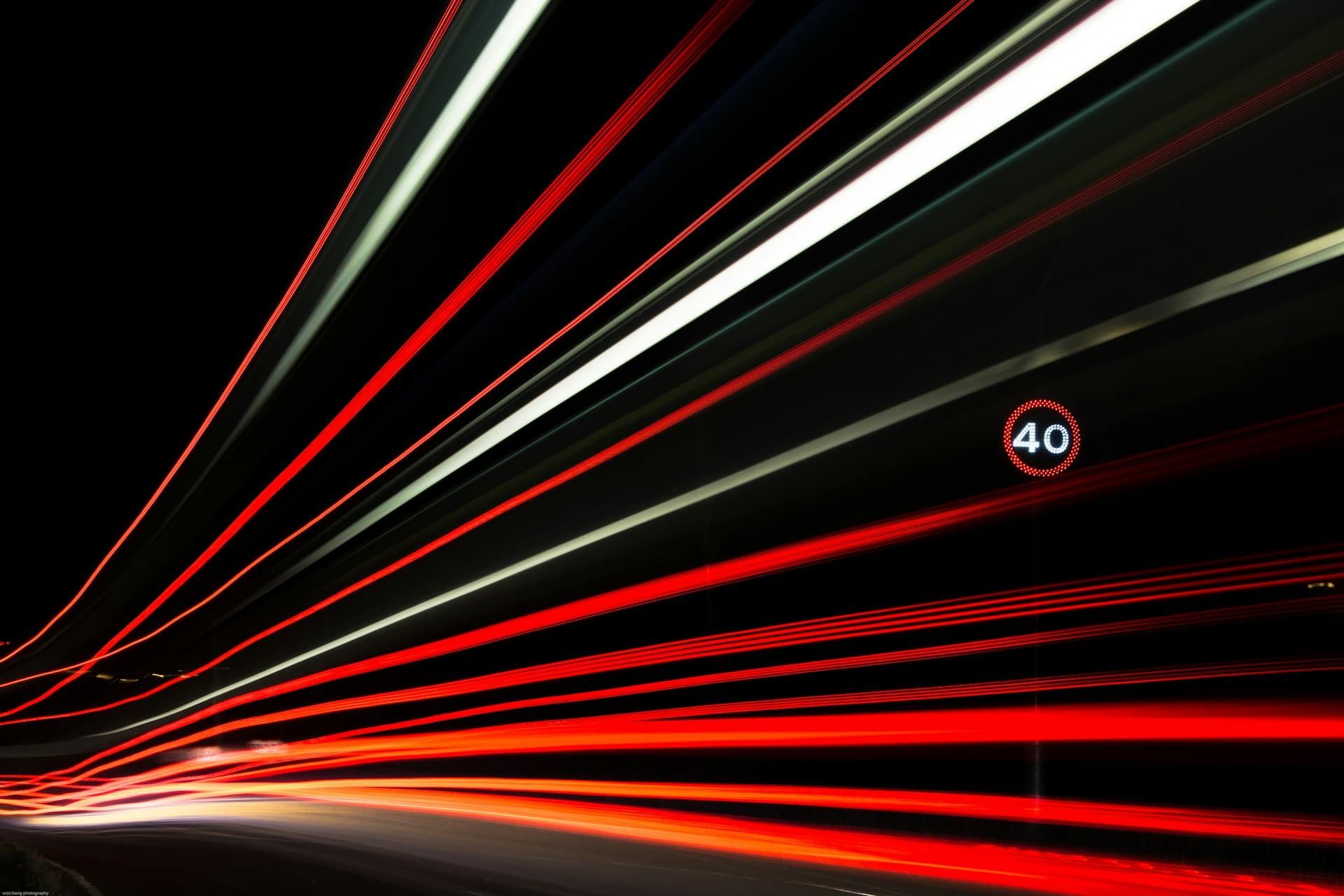 Long-exposure light trails settling into a single streak